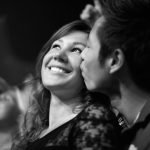married couple kissing at event
