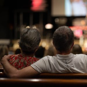 Man with arm around wife at Married Up Date night event